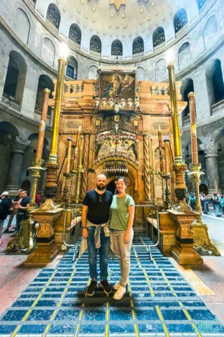 author of the posts with her husband stand in front of an ornately decorated altar inside a large, historic building.