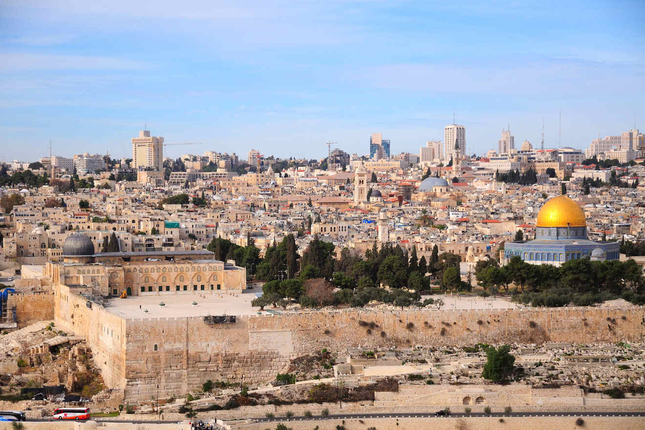 Panoramic view of Jerusalem with the Dome of the Rock in the foreground and modern cityscape in the background.